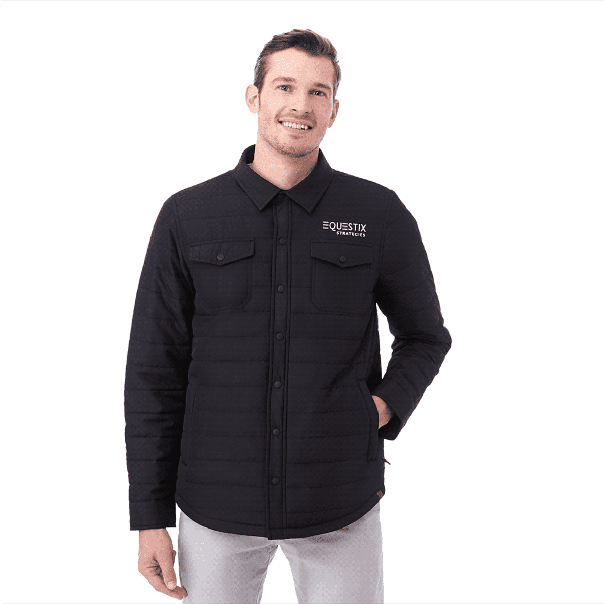A man wearing a black insulated shacket with two front pockets and a logo on the chest.