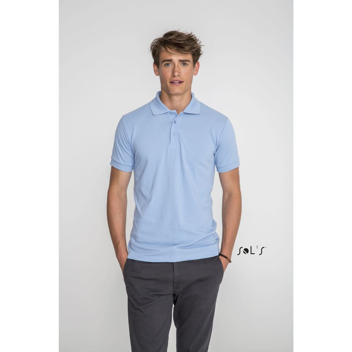 A light blue men's polo shirt made of 65% polyester and 35% ring spun cotton. The shirt features a logo.