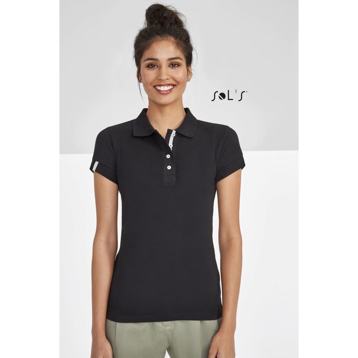 A black women's polo shirt made of 100% ring spun cotton, featuring a logo and short sleeves.