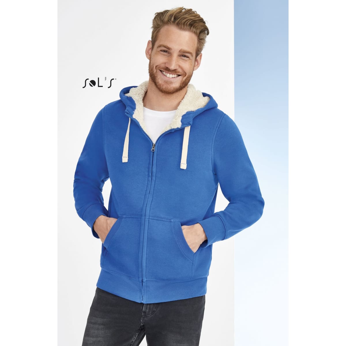 A blue unisex hoodie with a super warm Sherpa lining, featuring a zip and pockets. It has a logo on the chest.