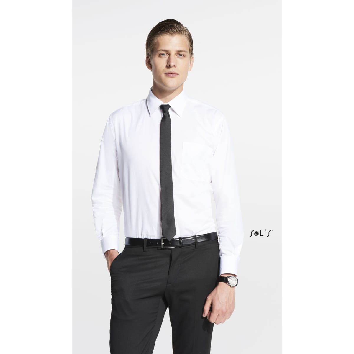 A man in a white shirt and black tie stands confidently, wearing black trousers and a watch. The image features a logo.