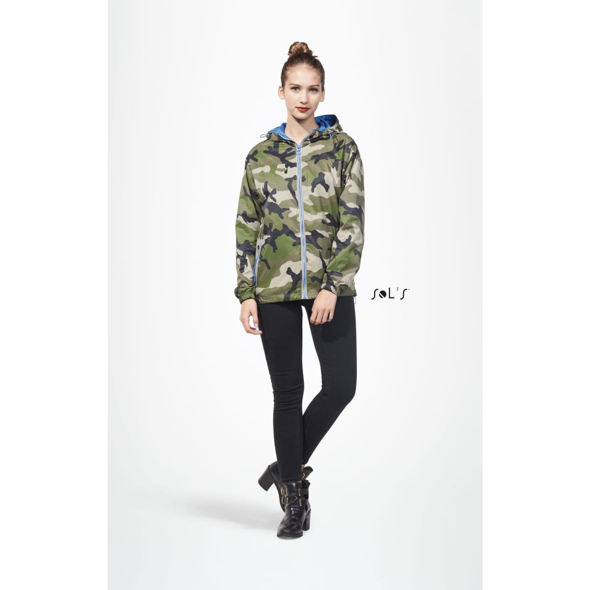 A unisex hoodie in camouflage pattern, featuring a hood and zip closure, paired with black skinny pants and boots.