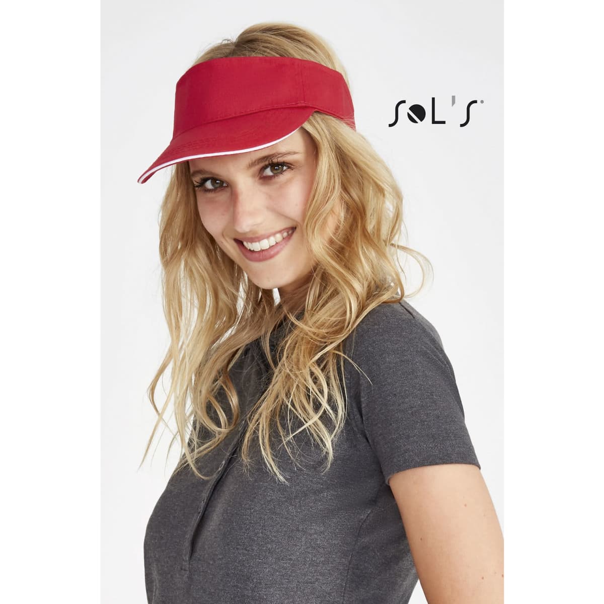 A red visor with a white trim worn by a smiling woman, featuring a logo on the side.