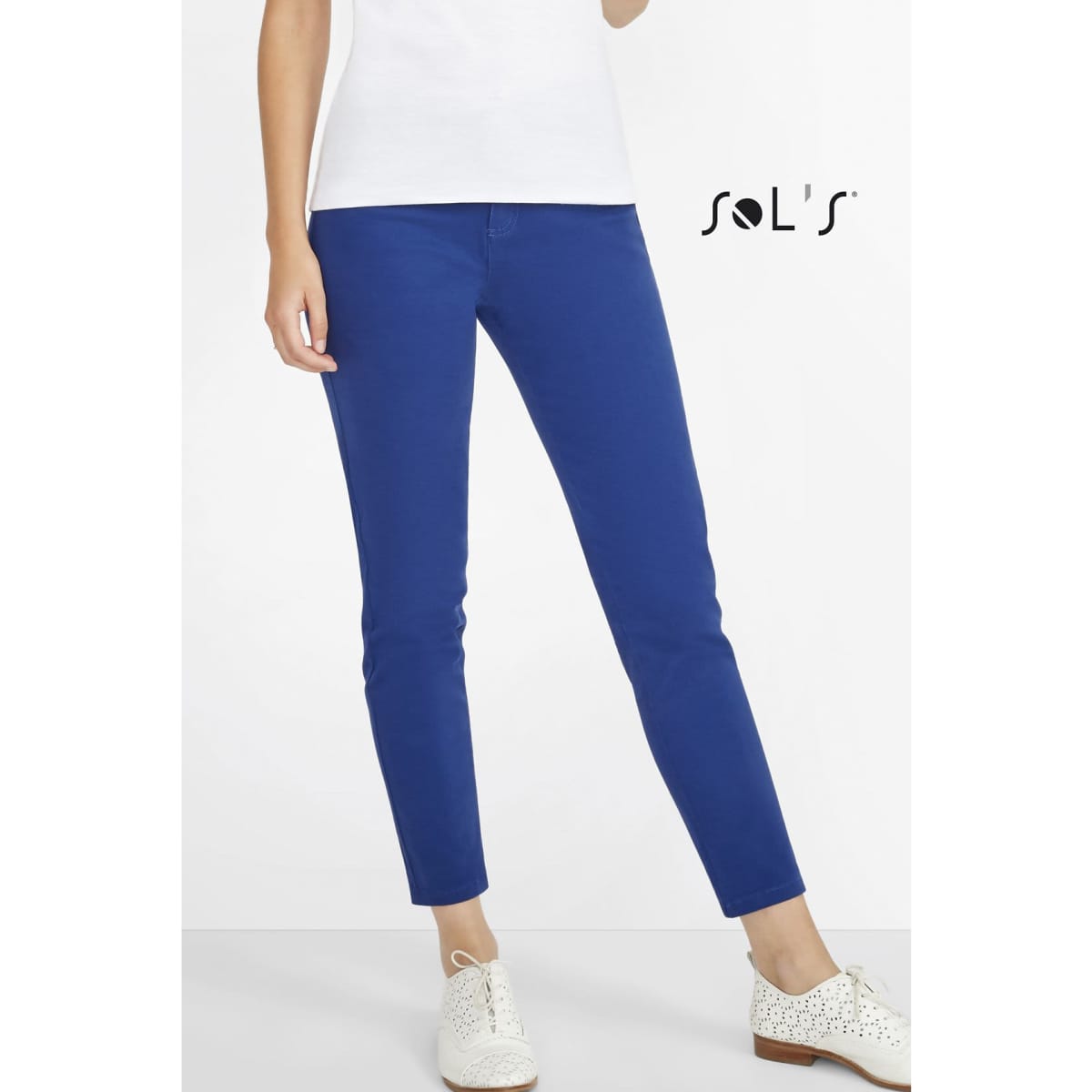 A pair of women's chinos in bright blue, featuring a modern 7/8 leg cut, worn with a white top and shoes.