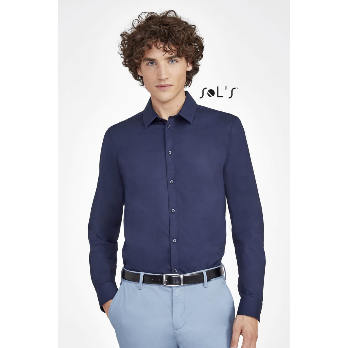A long sleeve stretch shirt in navy blue worn by a model, featuring a collar and button-up design. The shirt has a branding logo.