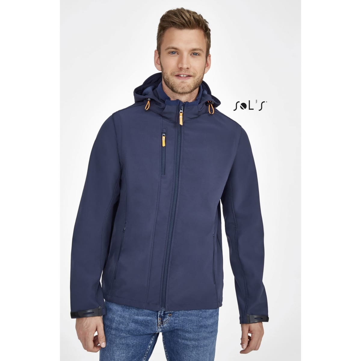 A navy blue unisex soft shell jacket with a removable hood and sleeves, featuring a logo on the chest.