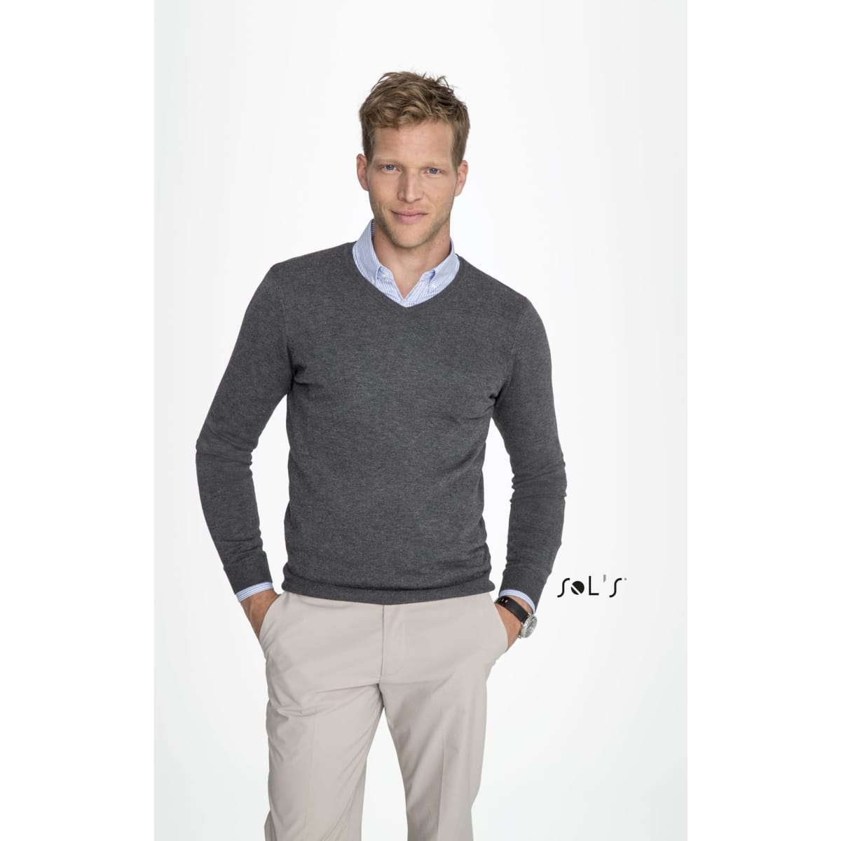 A grey V-neck men's jumper worn over a light blue shirt, modelled by a man with short blonde hair. Features a logo.