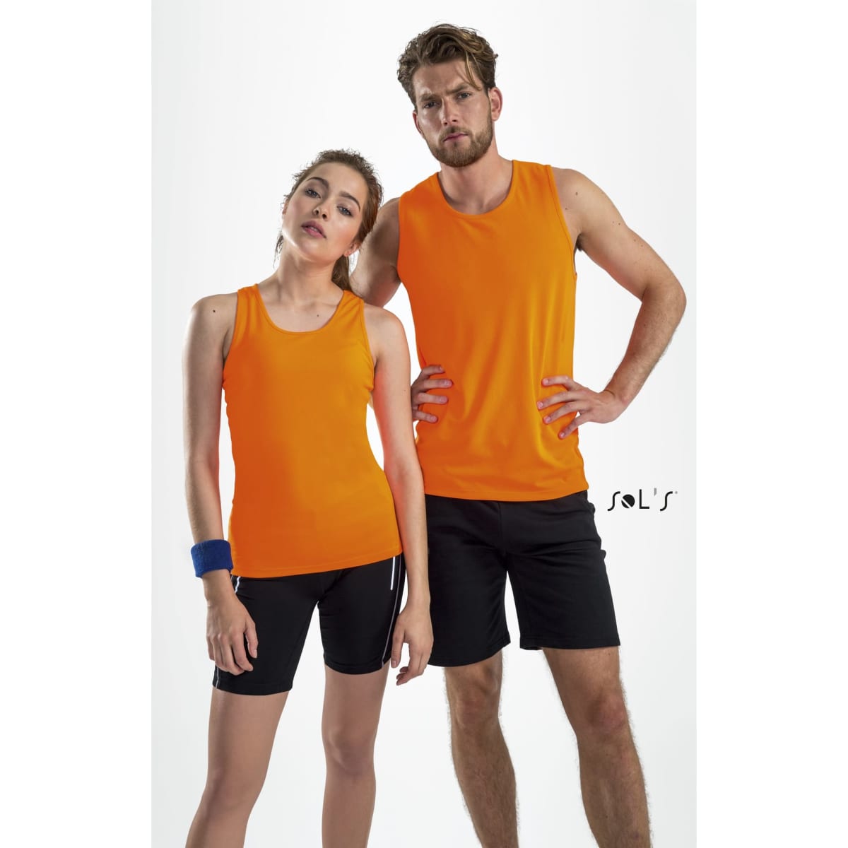 Two models wearing bright orange tank tops made of 100% breathable polyester, paired with black shorts.