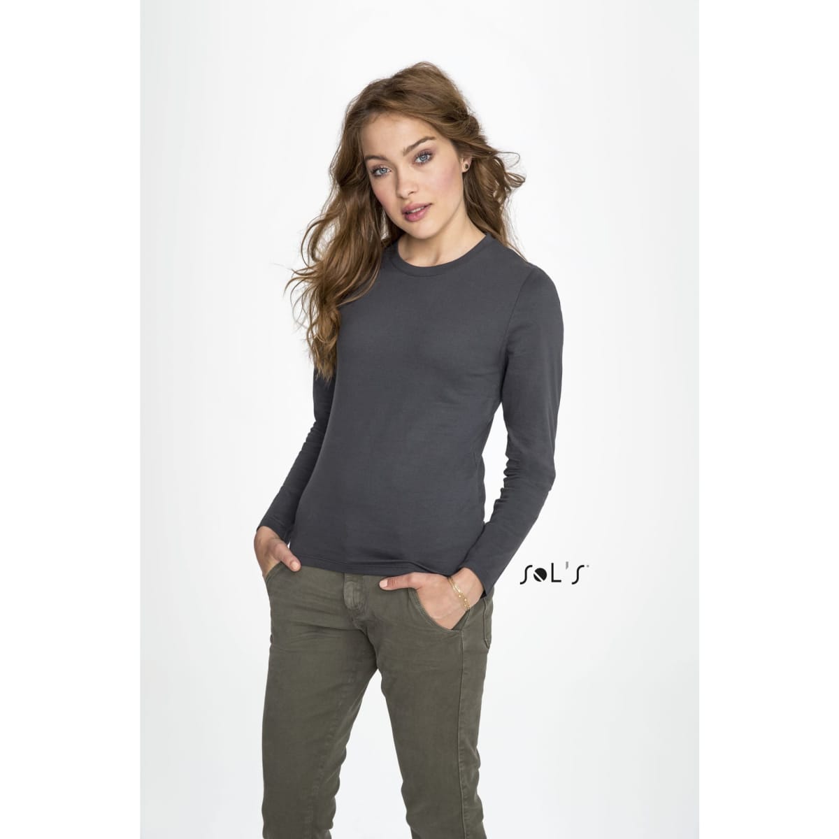 A long sleeve women's T-shirt in dark grey made from 100% semi-combed ring spun cotton, featuring a brand logo.