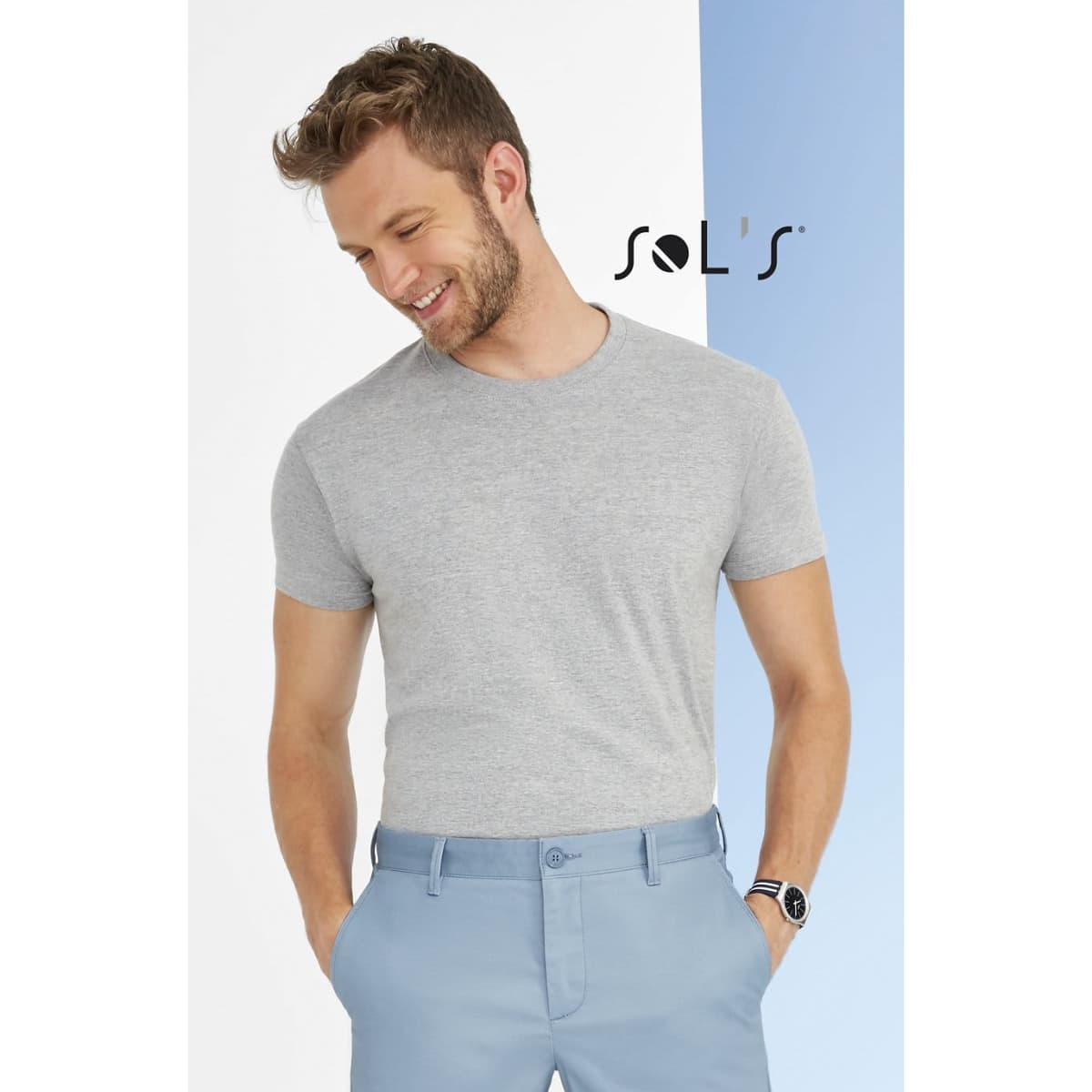 A grey t-shirt paired with light blue trousers, featured against a two-tone backdrop with a logo.