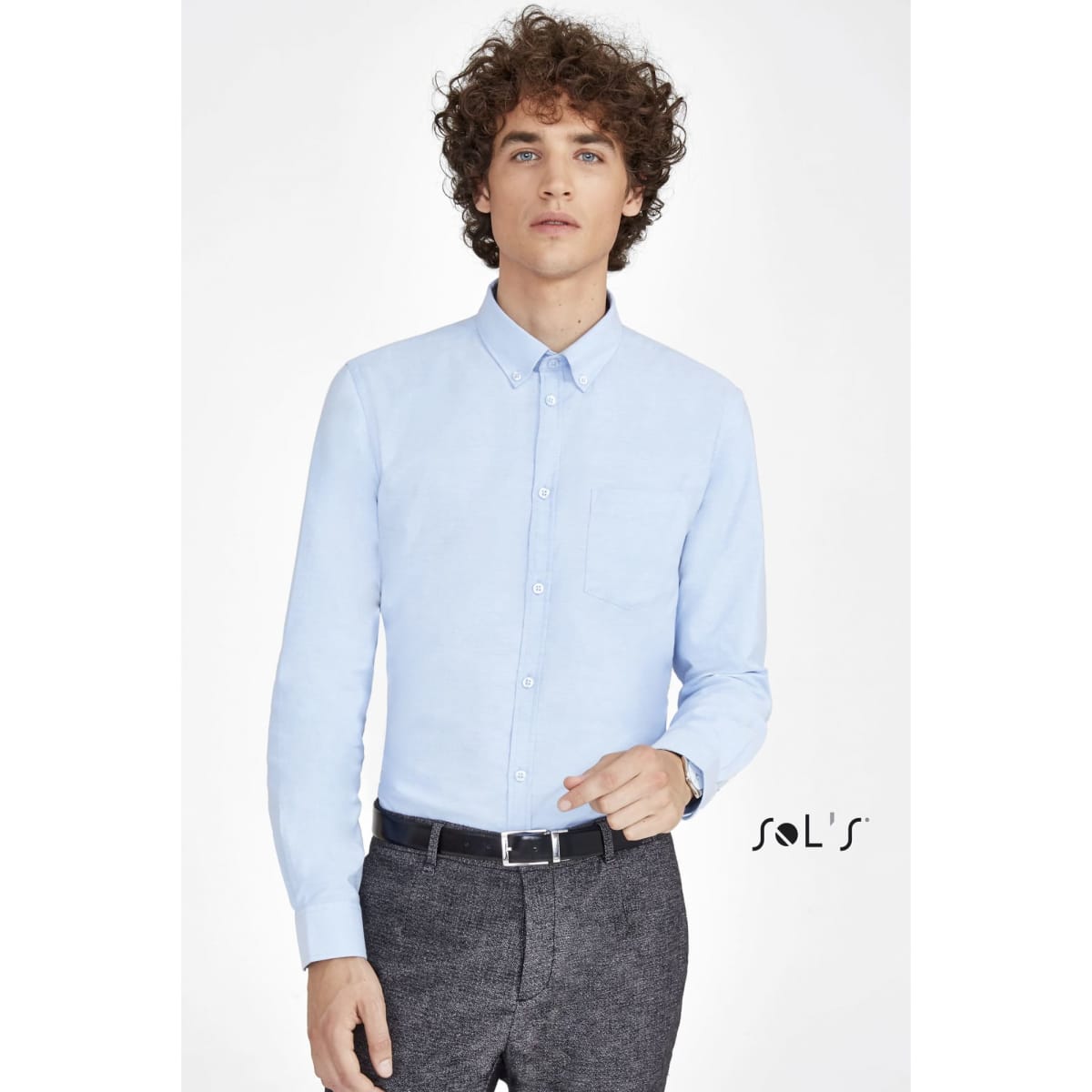 A light blue long sleeve Oxford shirt for men, featuring a button-down front and a chest pocket. It has a logo.