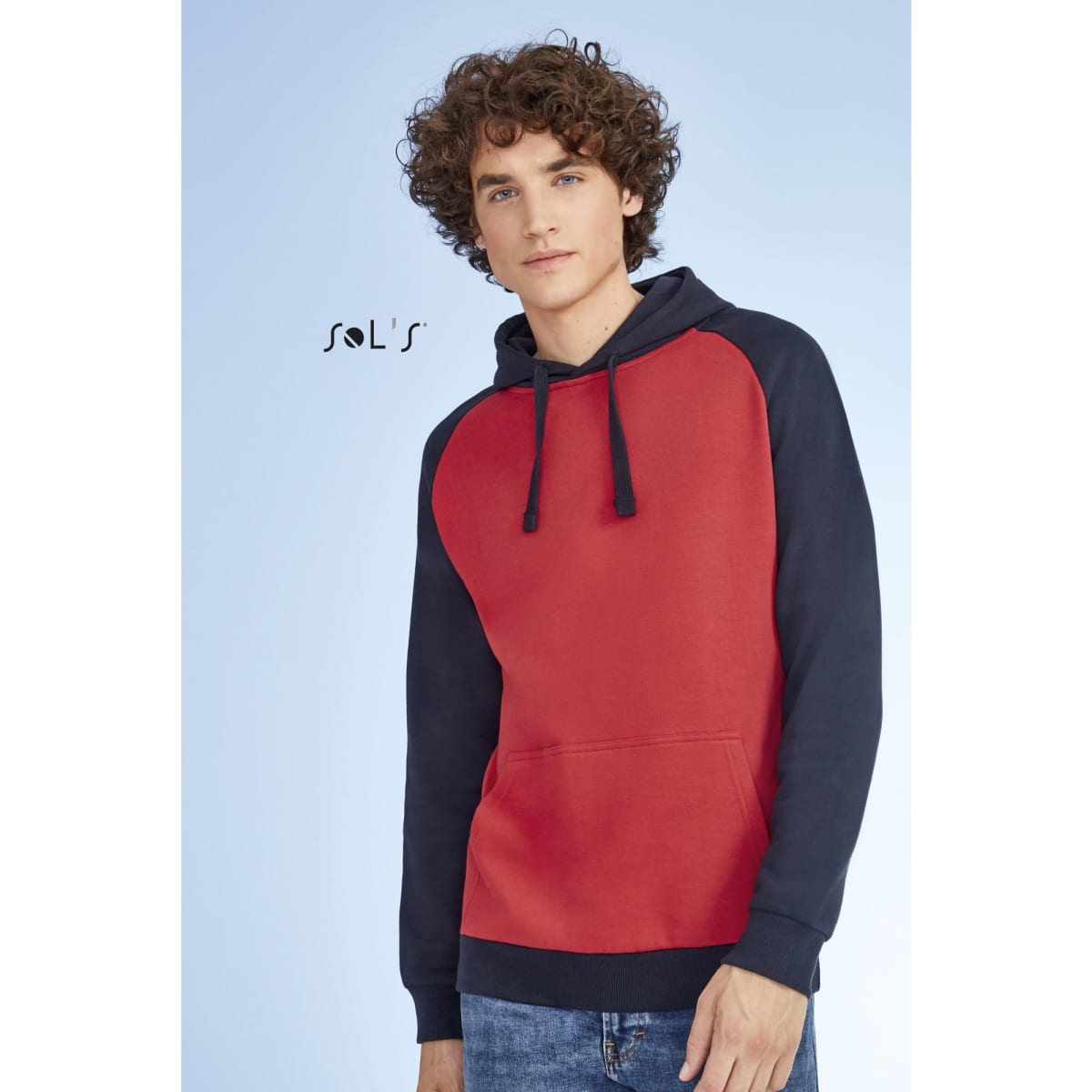 A two-tone unisex hoodie featuring raglan sleeves in red and navy, made from 80% ring spun cotton and 20% polyester.