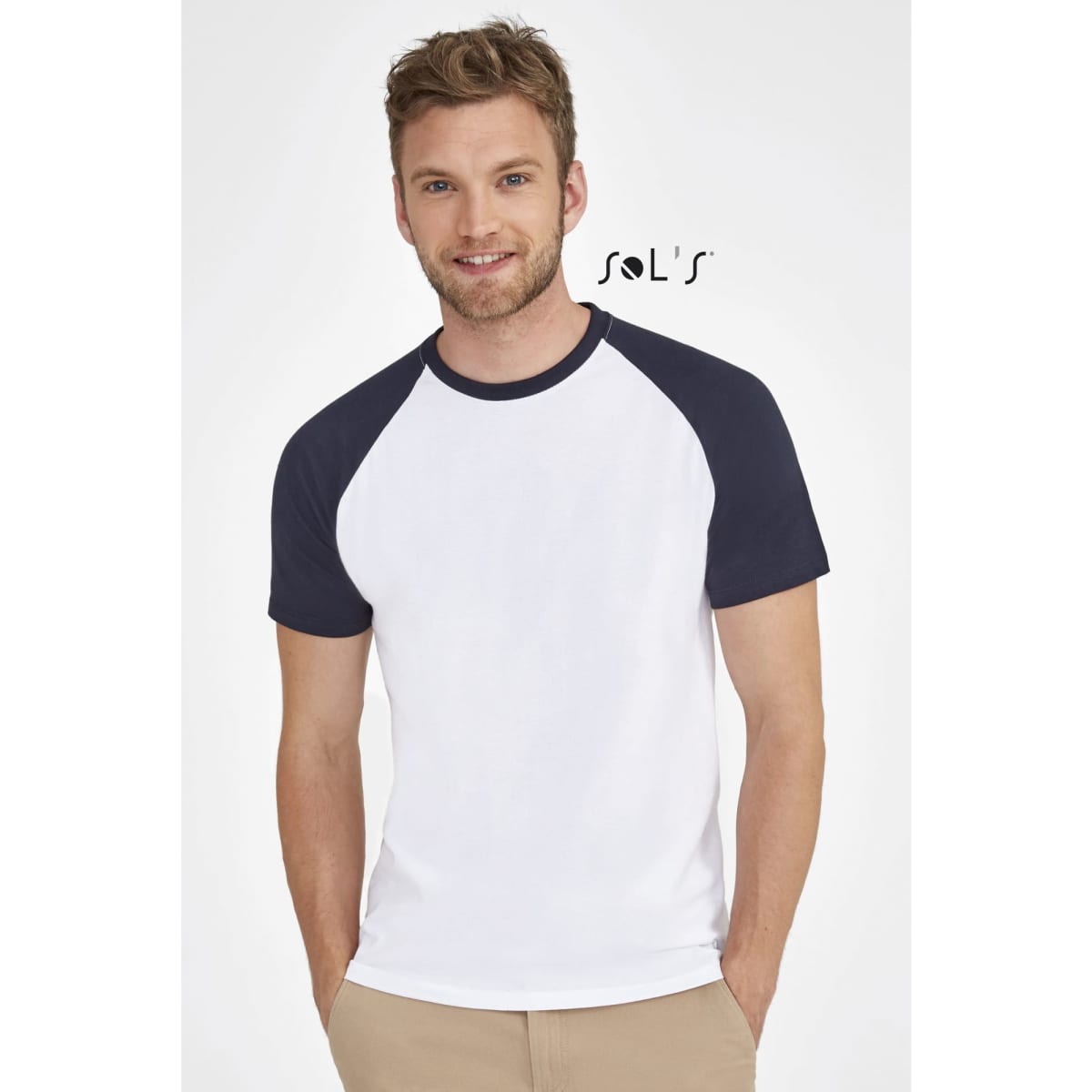 A two-colour raglan sleeve t-shirt featuring a white body with navy sleeves. The model is smiling and has a casual look.