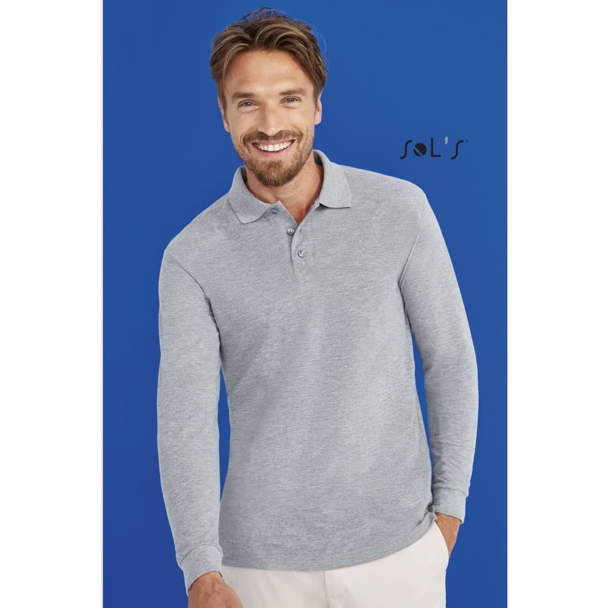 A grey long-sleeve jumper with a collar and button down made from 100% combed ring spun cotton. It features a logo.