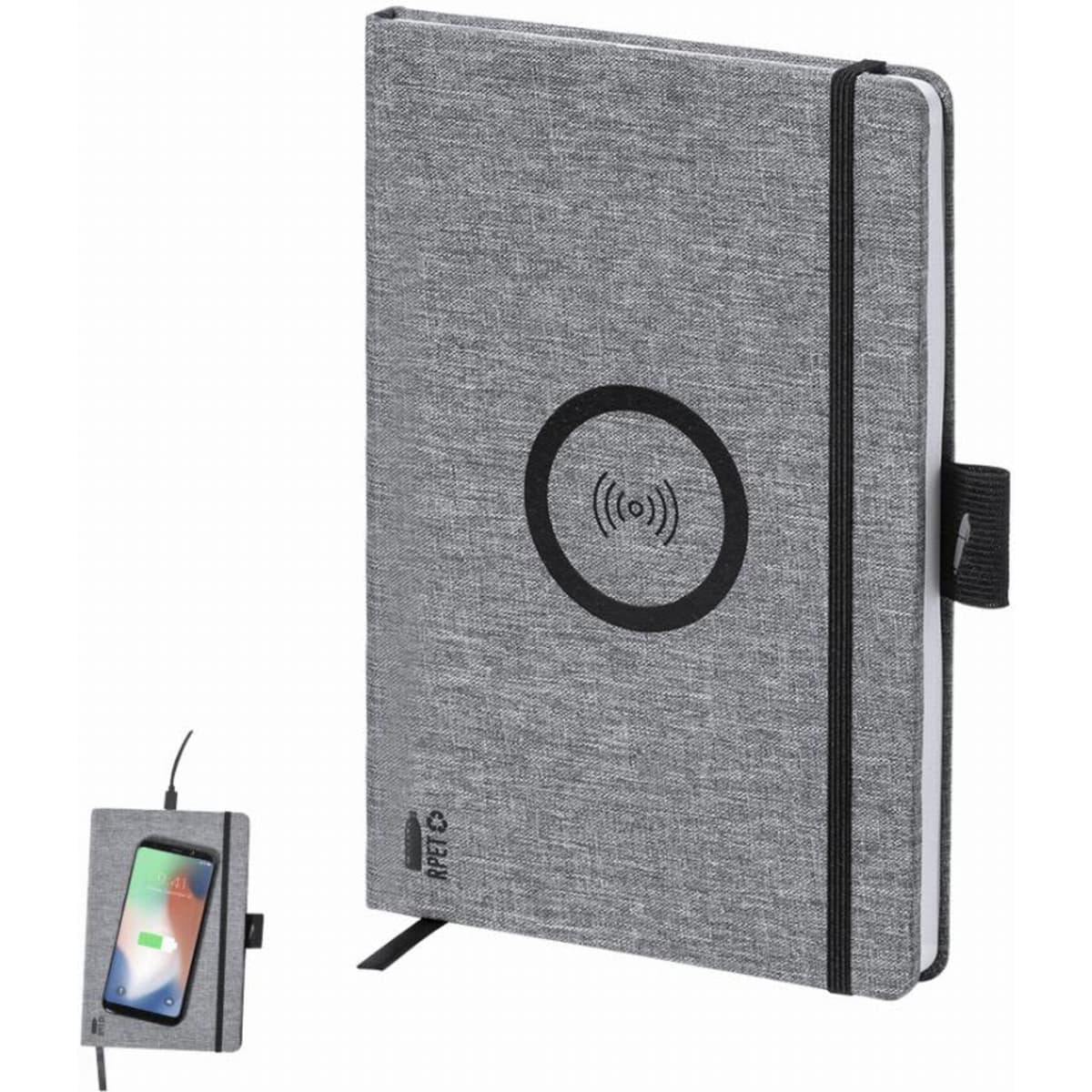 A grey notebook with a wireless charging pad and a small phone resting against it. It features a black logo.