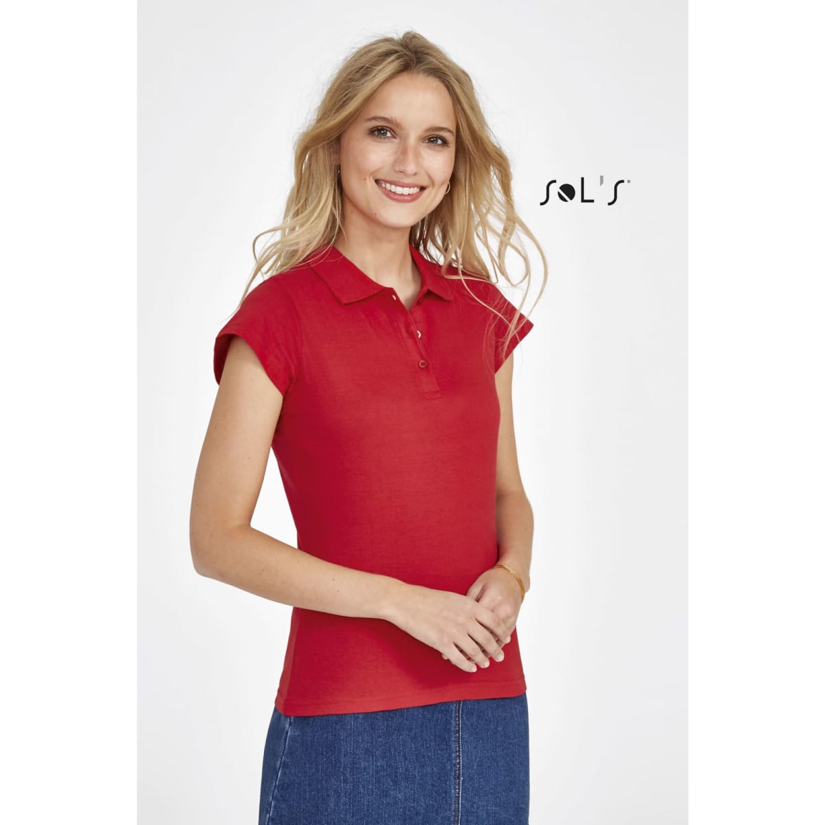 A red women's polo shirt made from 100% semi-combed ring-spun cotton, featuring a collar and cap sleeves.