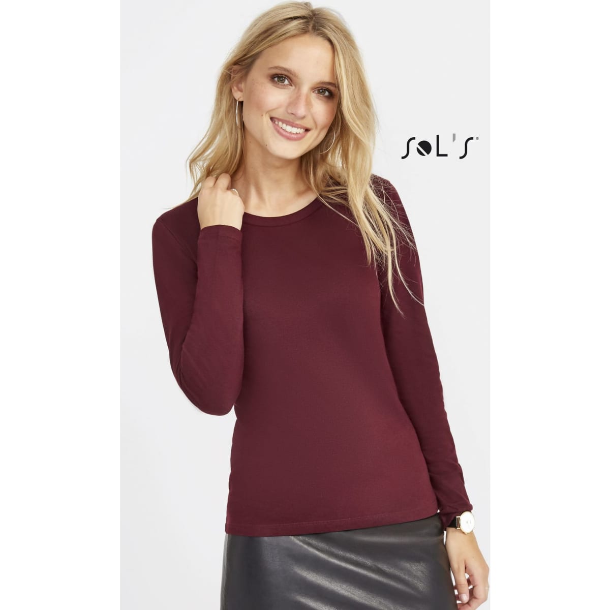 A long sleeve women's T-shirt in burgundy, featuring a round neck and ribbed neck design, with a logo present.