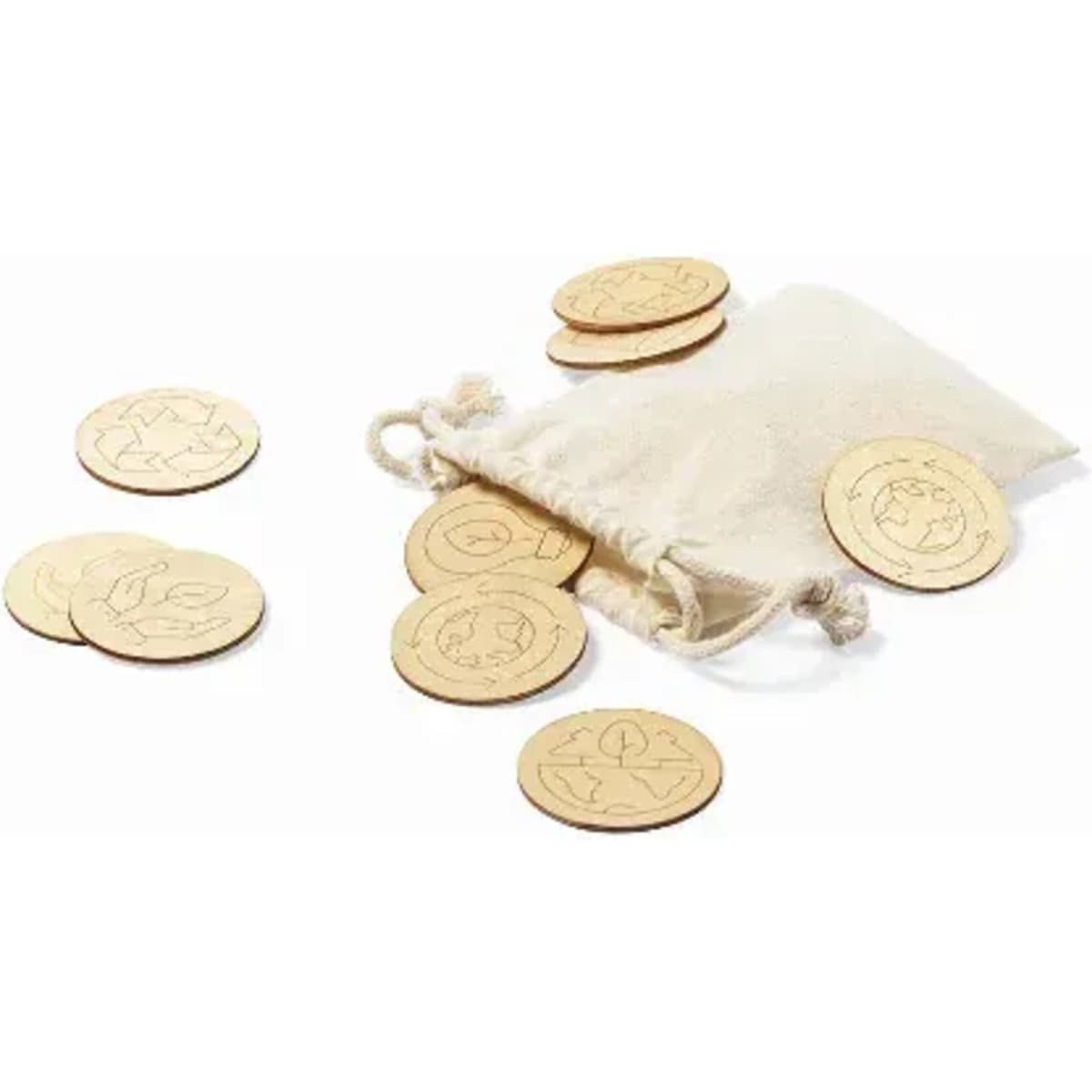 A muslin pouch contains wooden tokens with various engraved designs, scattered around on a white background.