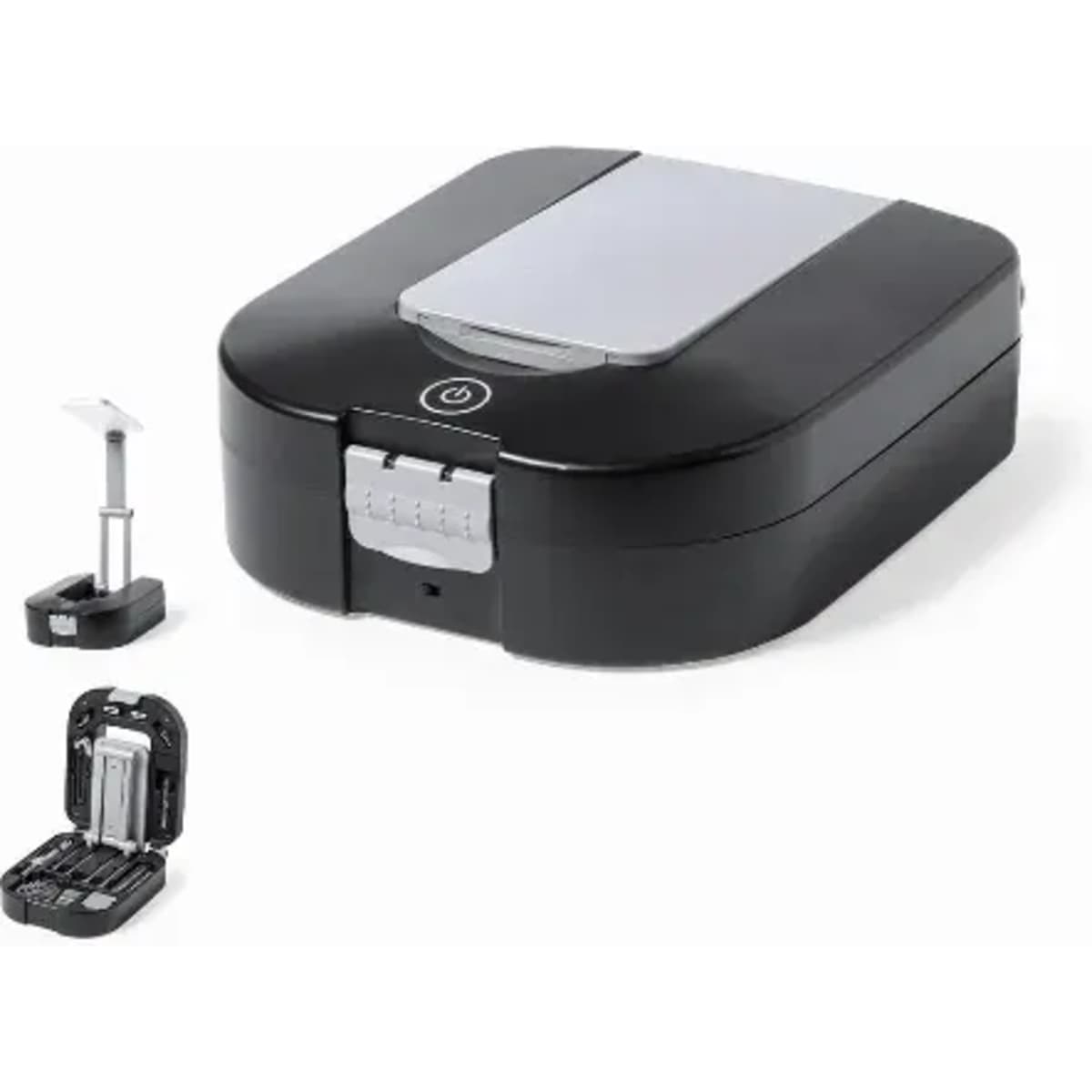A black and silver device with a hinged lid, accompanied by a small accessory and a compact storage case.