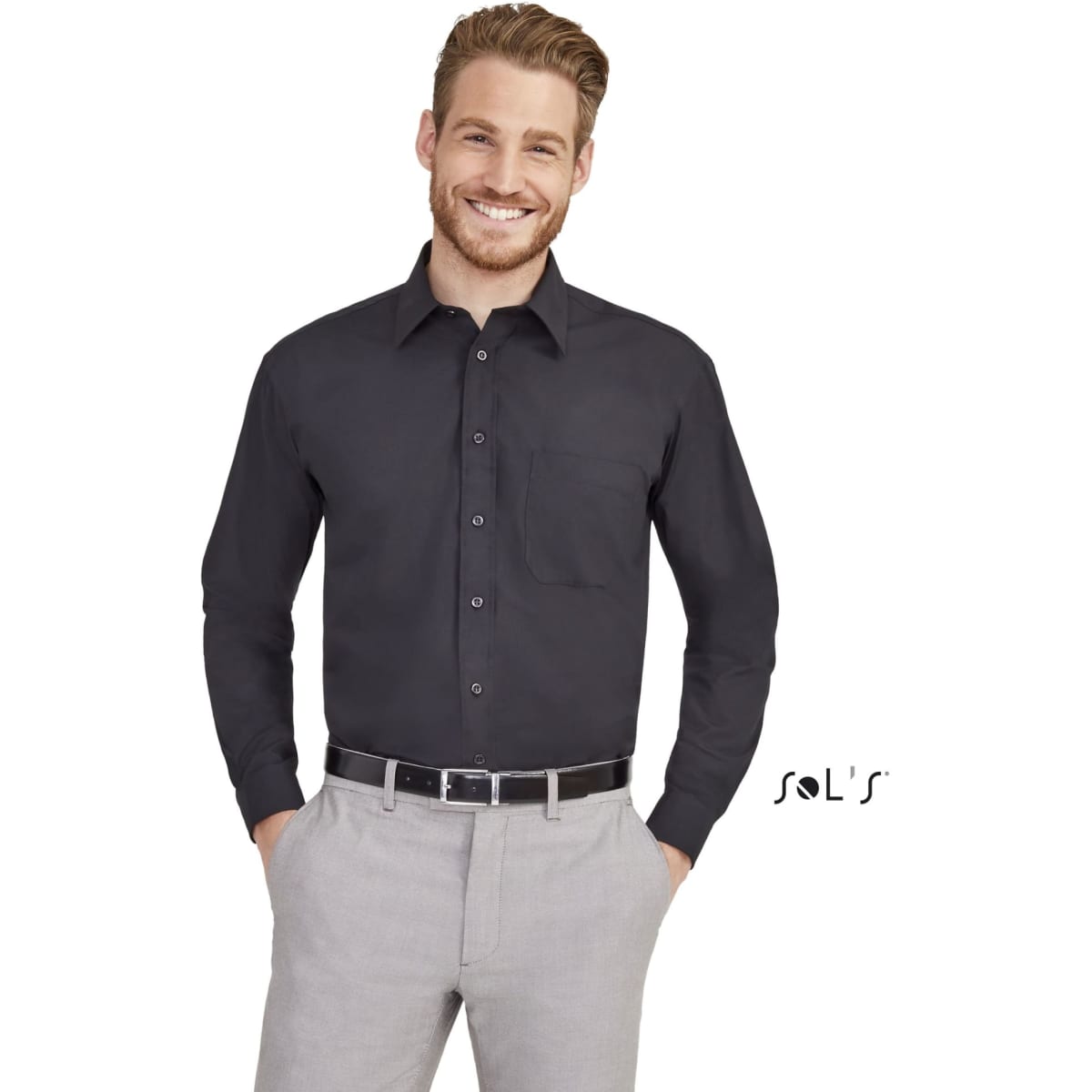 A long sleeve poplin business shirt in black, featuring a pocket and a brand logo, worn with light grey trousers.