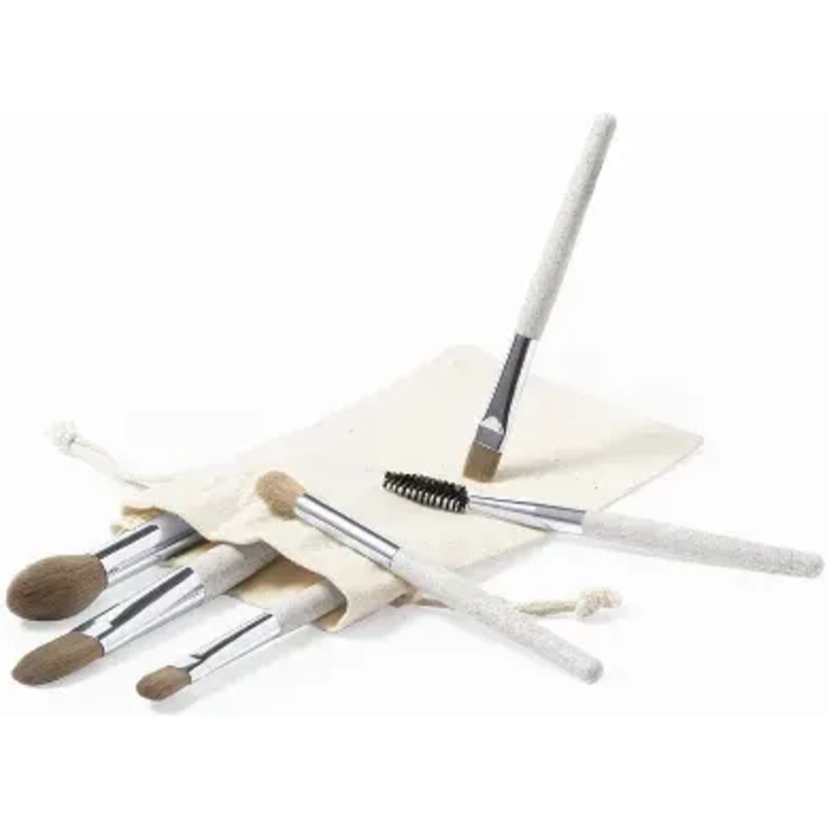 A brush set with various makeup brushes in a cream-coloured fabric pouch. The brushes feature silver handles.