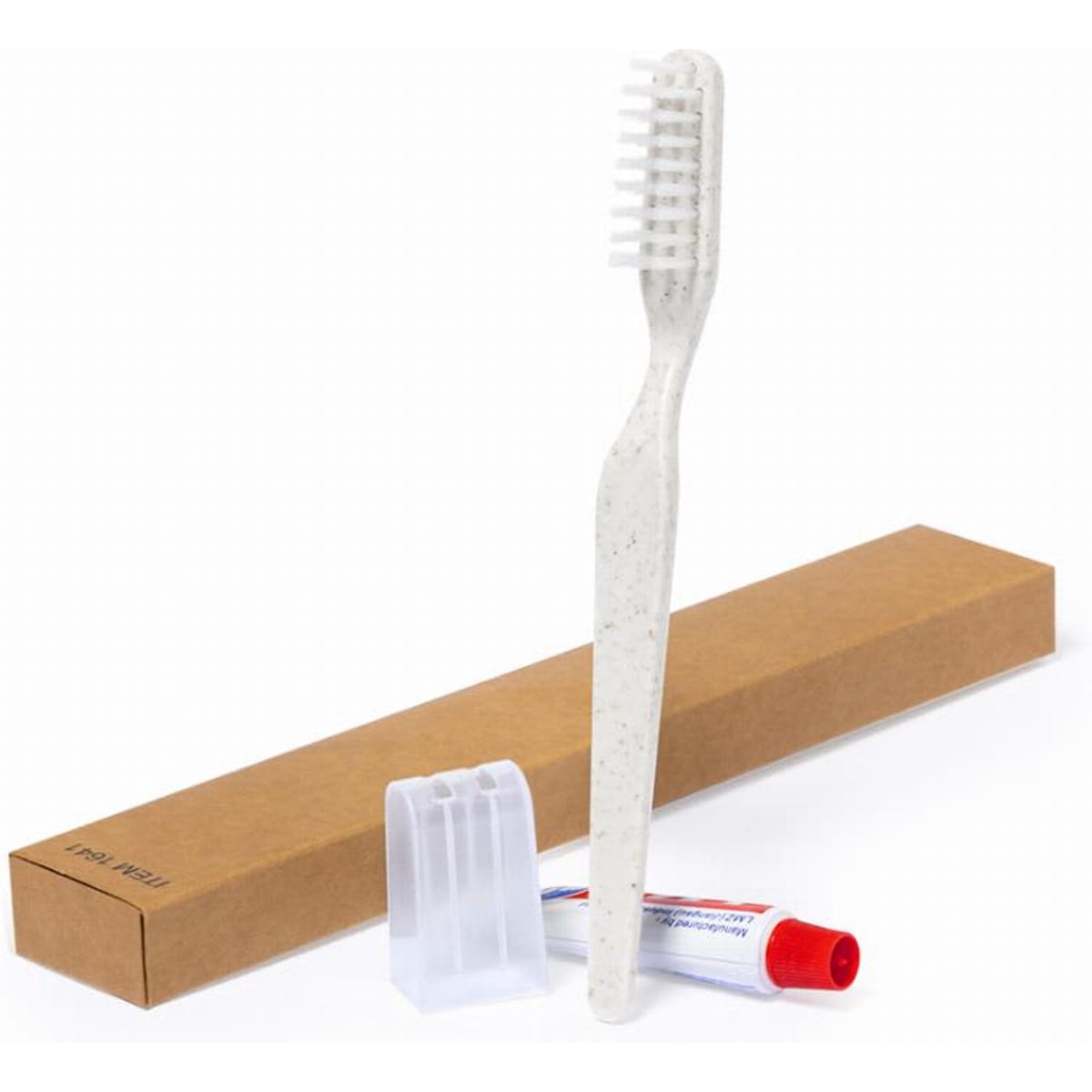 A dental kit featuring a white toothbrush, toothpaste, and a clear travel cap, all presented in a brown box.