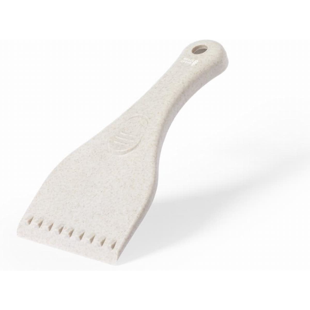 A scraper tool in a light cream colour with a textured handle and a flat, serrated edge. It features a logo.