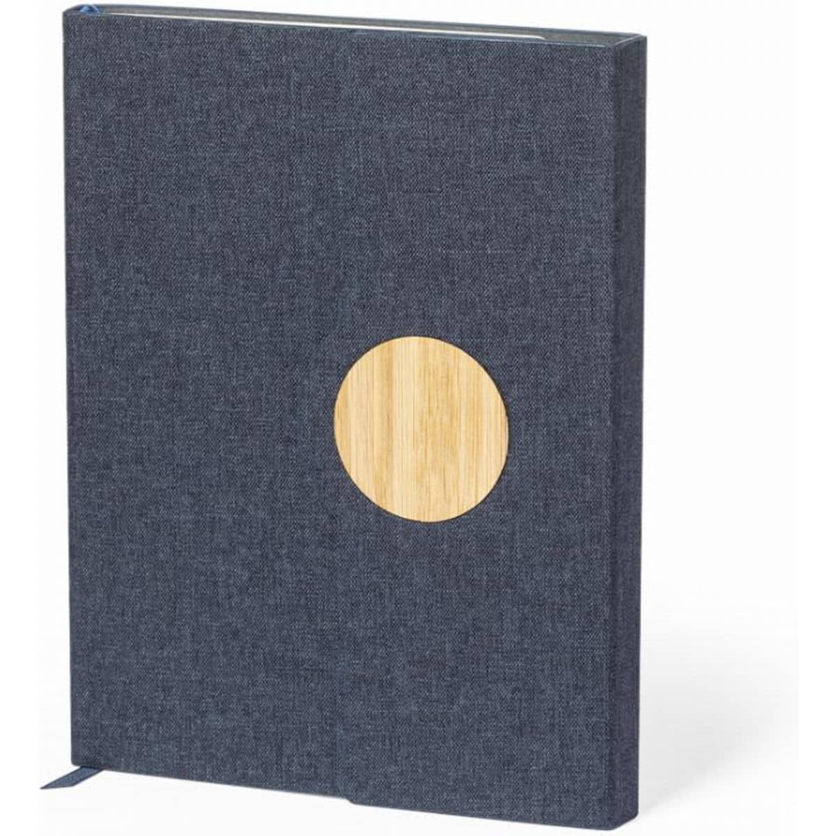 A notebook with a dark blue fabric cover and a circular bamboo accent. It features a ribbon bookmark.