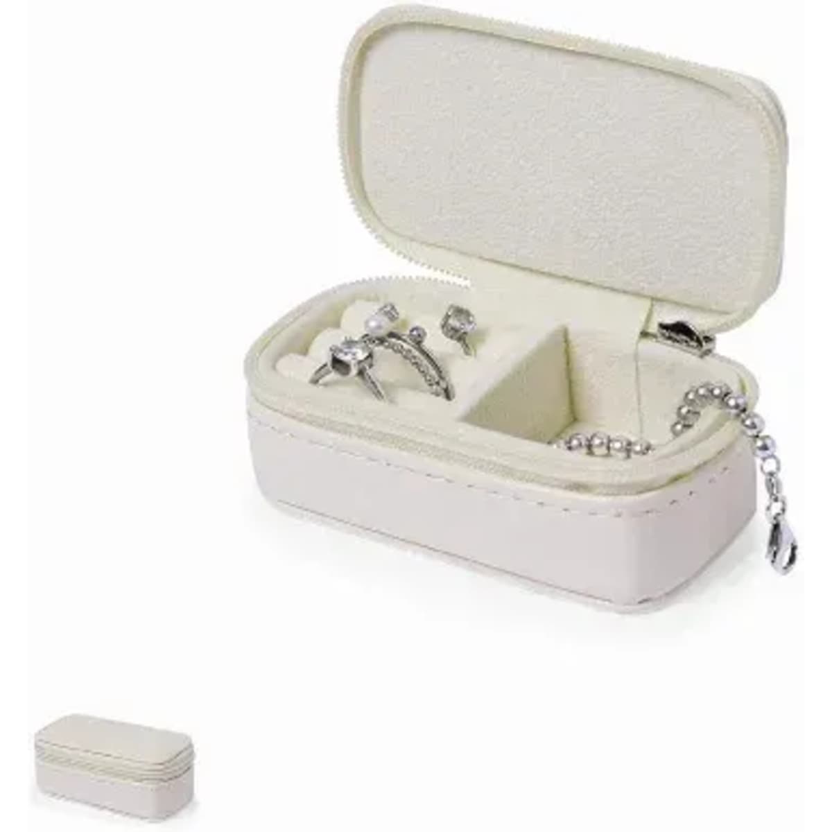 A jewellery box in white with a soft interior, containing various silver rings and a bracelet.