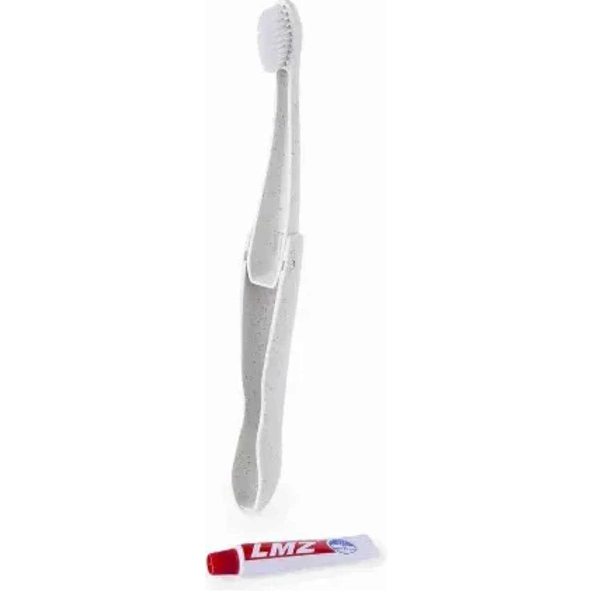 A toothbrush in white with a cap, positioned next to a red tube of toothpaste.
