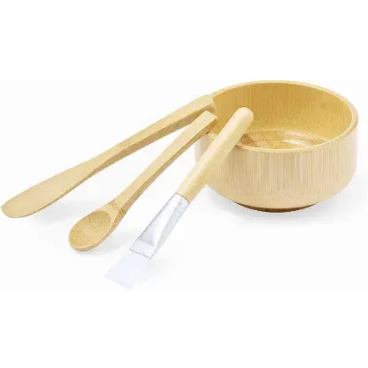 A bamboo skincare set featuring a mixing bowl, spoon, and spatula, all in a natural bamboo finish.