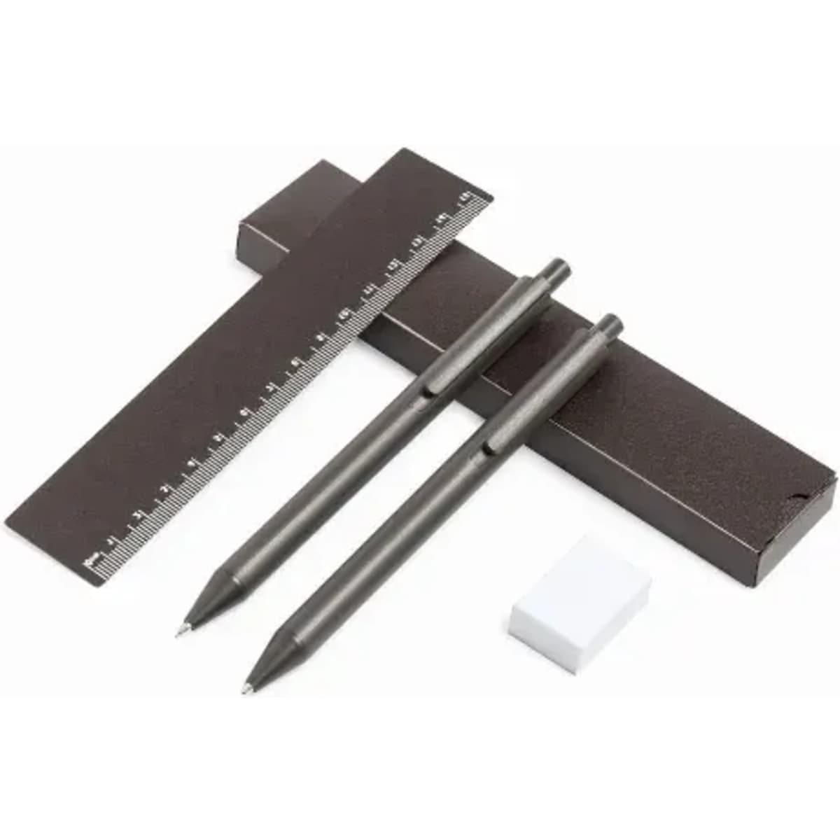 A set of black pens, a ruler, and an eraser, arranged on a white background. The ruler has measurement markings.