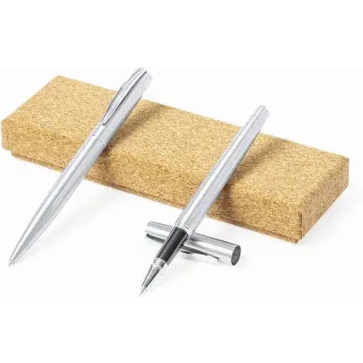 A set of silver pens resting on a rectangular cork block, showcasing their sleek design.