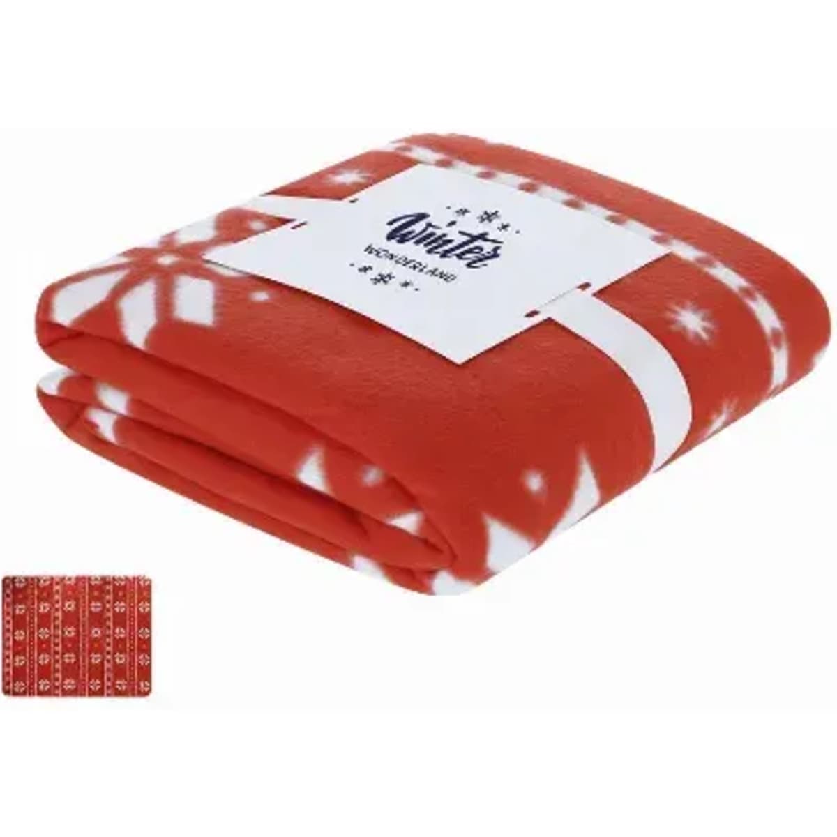 A red fleece blanket folded neatly with a snowflake pattern, accompanied by a small patterned fabric swatch.