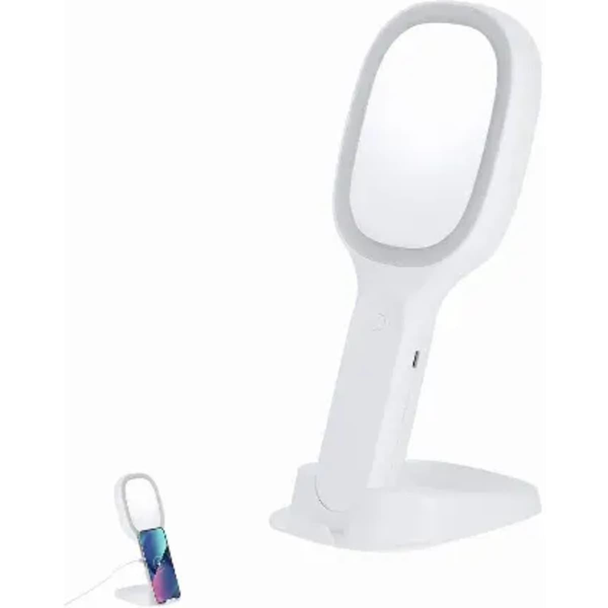 A white vanity mirror with a stand and a small multi-coloured cylindrical object beside it. The mirror has a touch of branding.