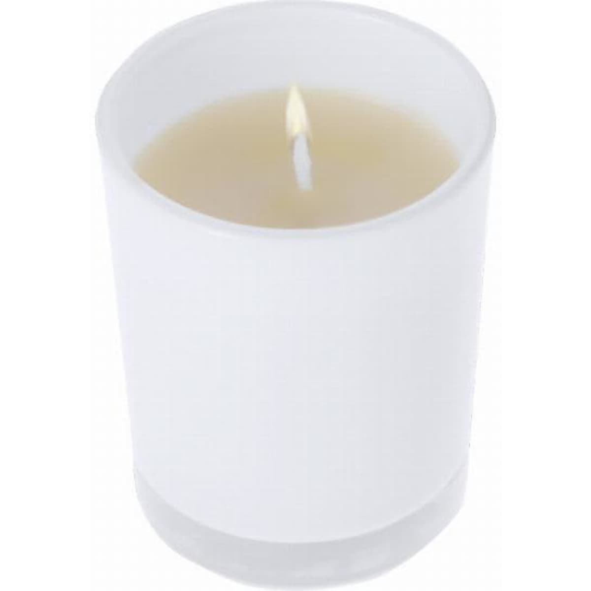 A white candle in a transparent glass holder with a lit wick, emitting a soft glow.