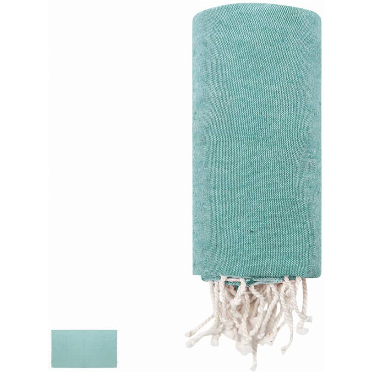 A teal towel with tassels, neatly rolled up, featuring a plain design. A smaller folded towel is visible beside it.