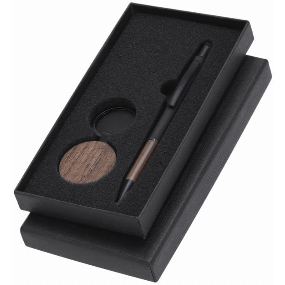 A gift box containing a black pen and a wooden coaster, set in black foam padding.