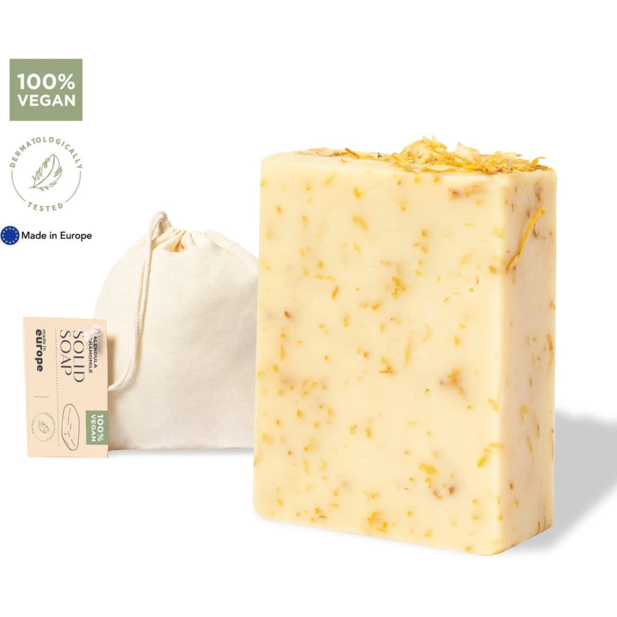 A bar of vegan soap with yellow and white tones, alongside a small fabric bag. It has a natural, textured appearance.