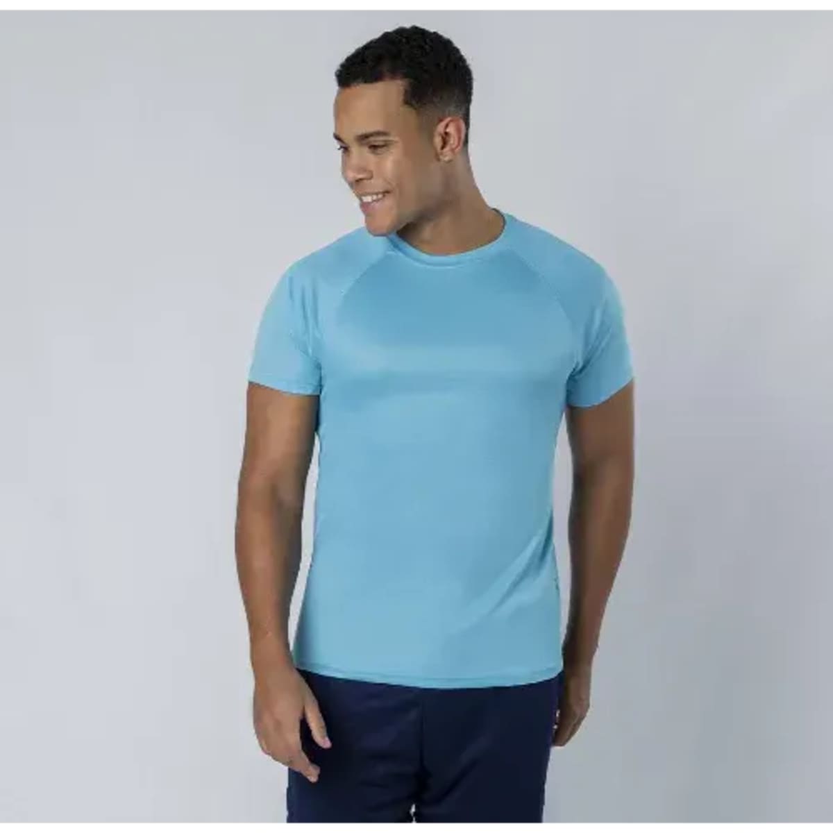 A light blue adult t-shirt with short sleeves, displayed on a male model against a plain background.