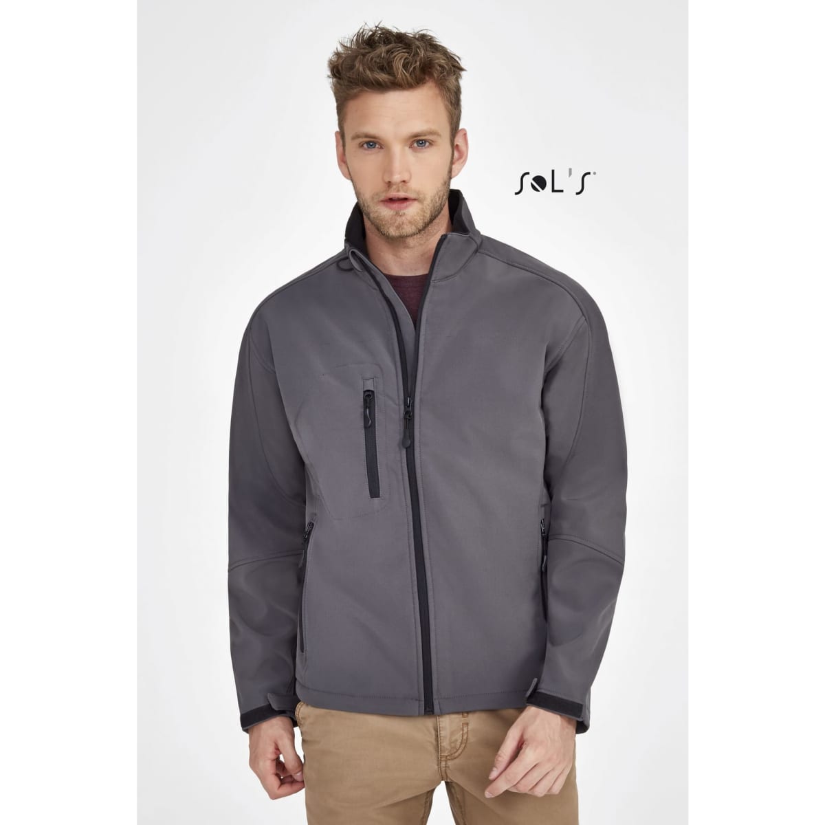 A men's softshell jacket in grey, featuring a zipped pocket and a sleek design, with a logo on the upper left.
