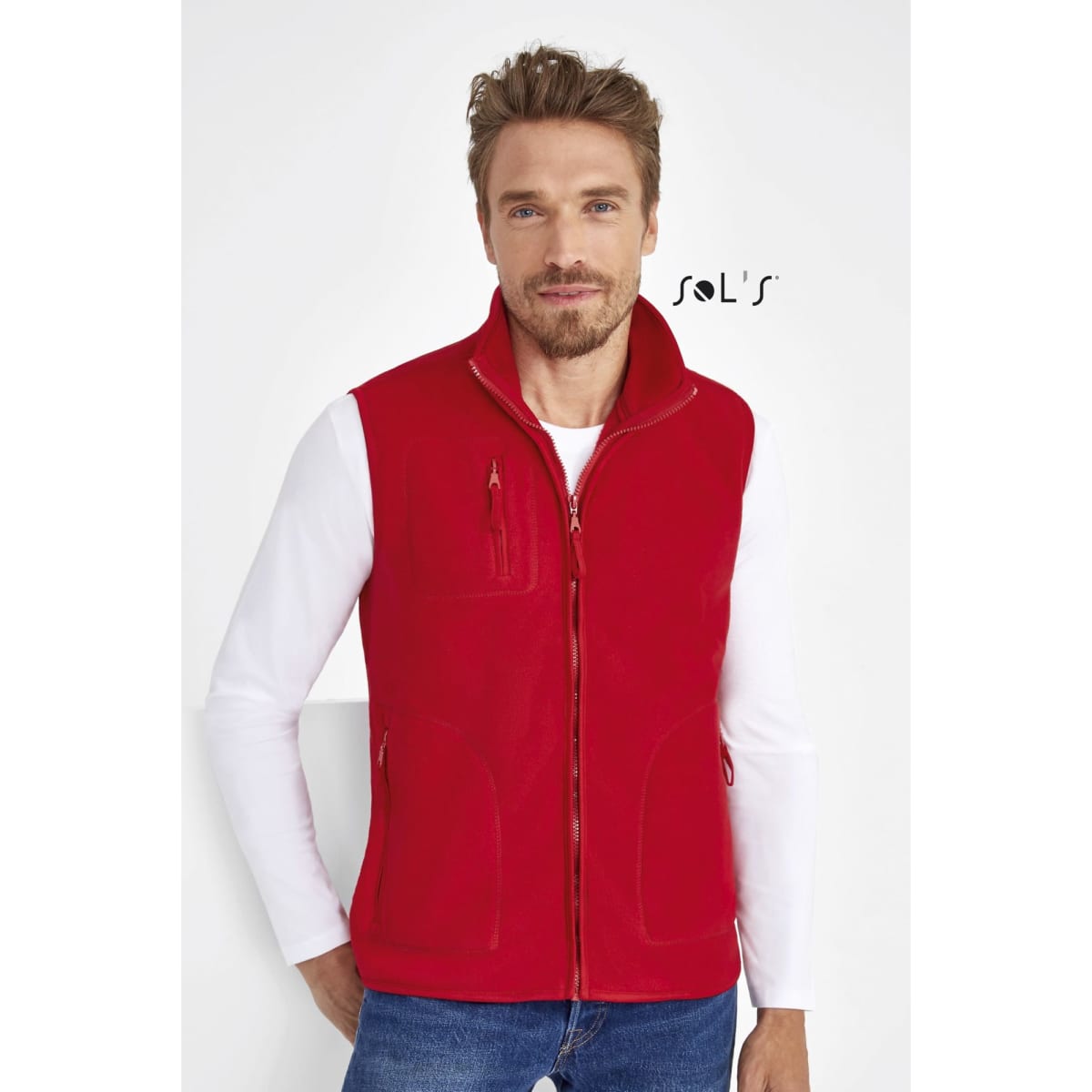 A red unisex fleece vest features a zip front and multiple pockets, displayed on a model. It has a branding logo.