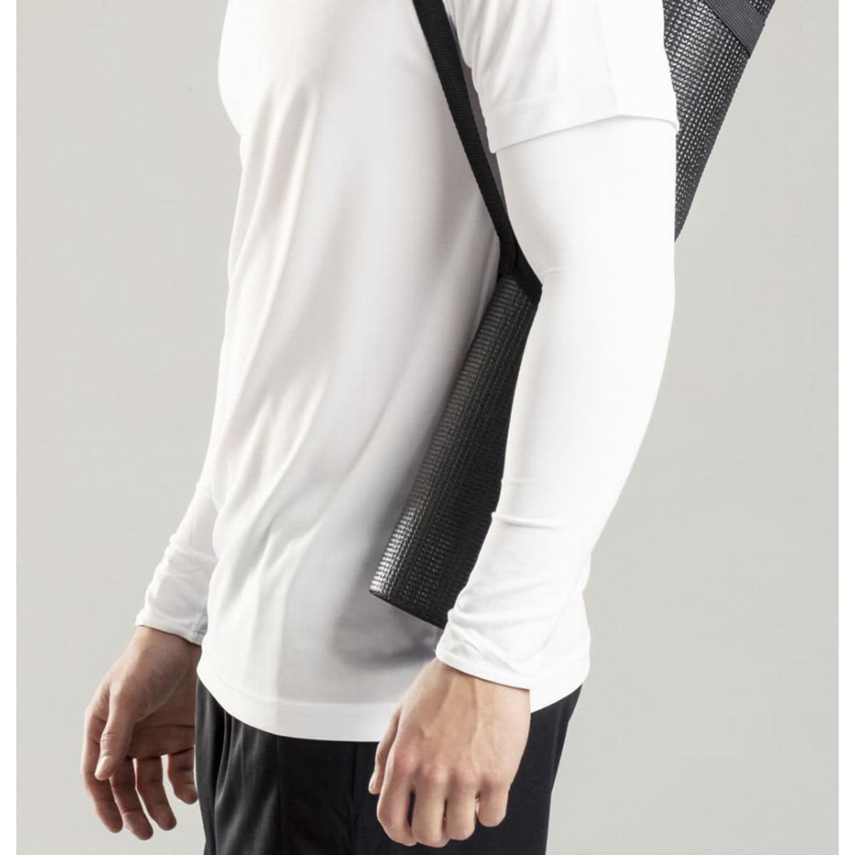 A drink bottle carrier in black, featuring a mesh design, held by a person wearing a white long-sleeve shirt.