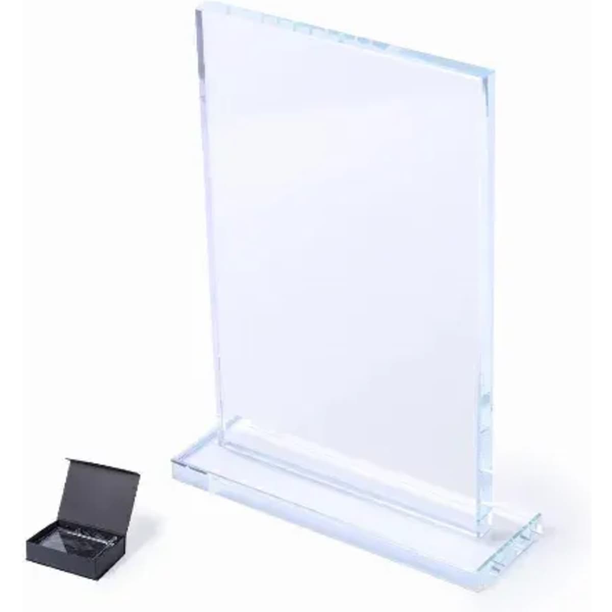 A clear acrylic award plaque stands upright on a base, next to a small black gift box.