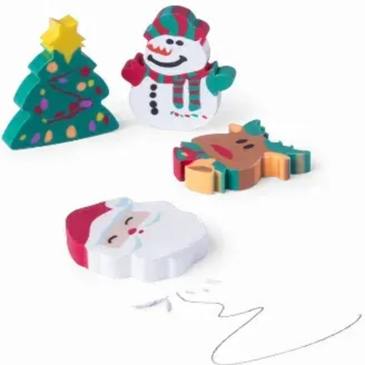 Colourful Christmas-themed erasers, including a tree, snowman, reindeer, and Santa, arranged on a white background.