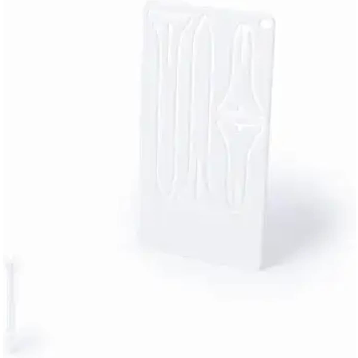 A white product featuring various grooves and a small tool on the side, possibly for shaping or crafting.