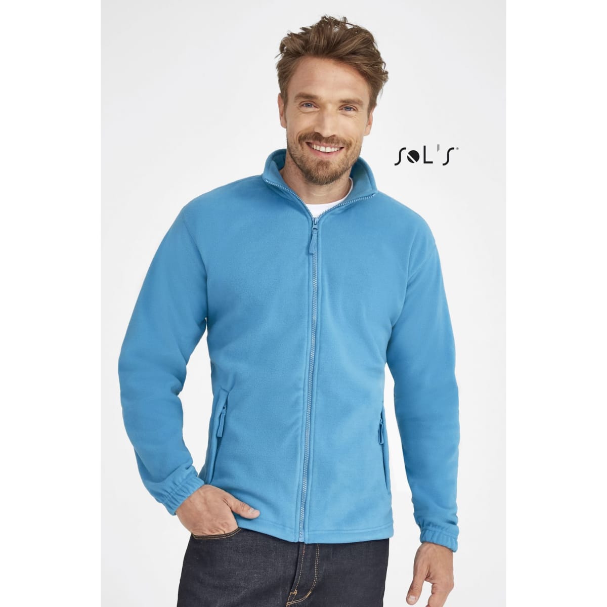 A zipped fleece jacket in bright blue, featuring a high collar and side pockets, modeled by a smiling man.