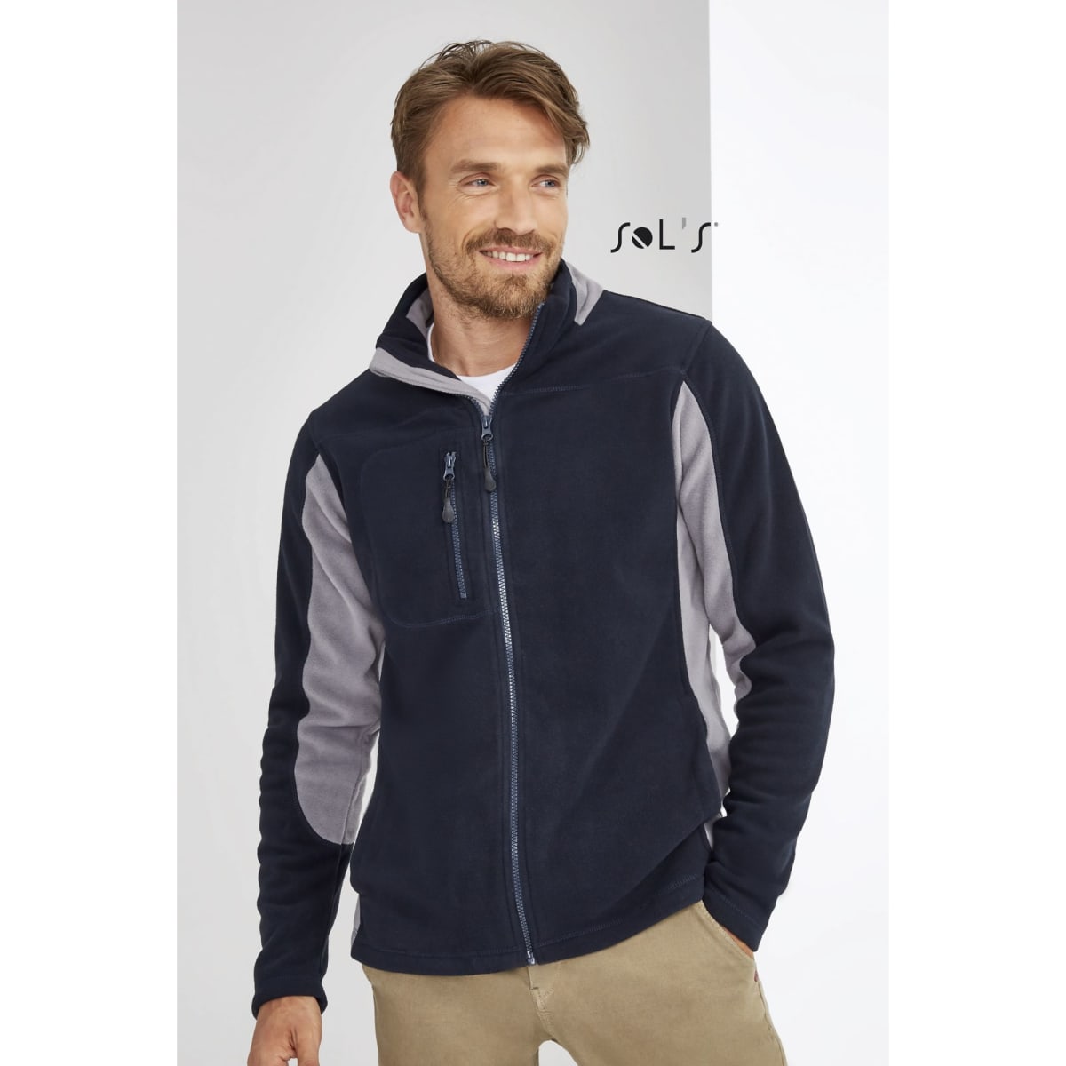 A men's zippered polar fleece top in navy blue with grey accents, featuring a chest pocket and a collar.