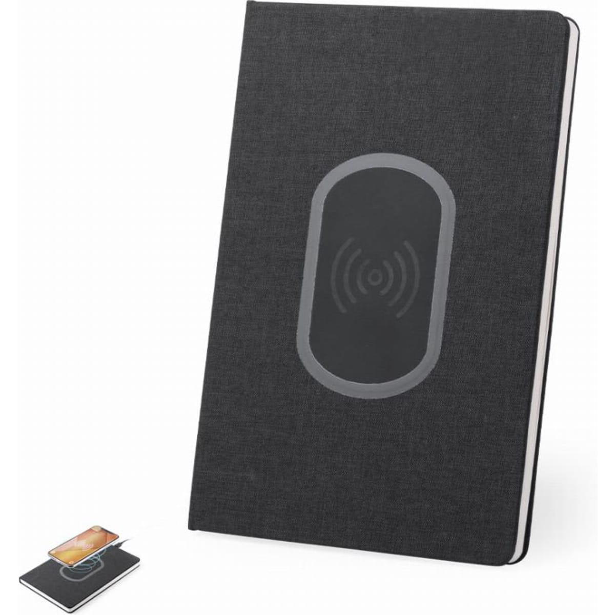 A notebook with a black fabric cover featuring a wireless charging pad design, alongside a small card-sized device.