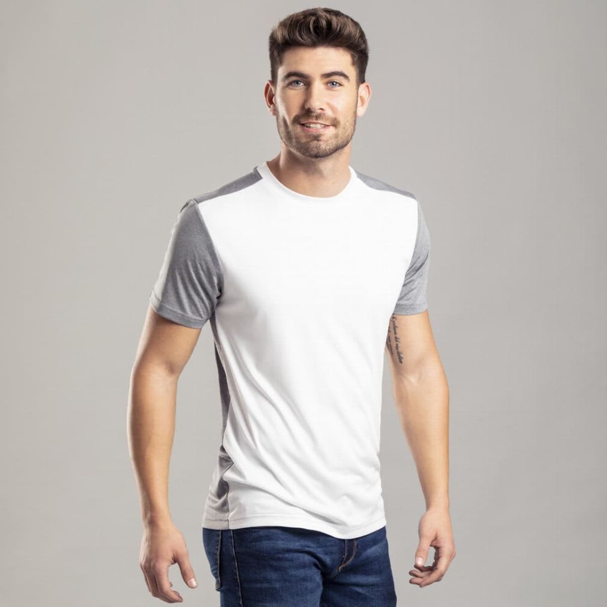 A casual T-shirt in white with grey sleeves, displayed by a smiling male model. The product features a logo.